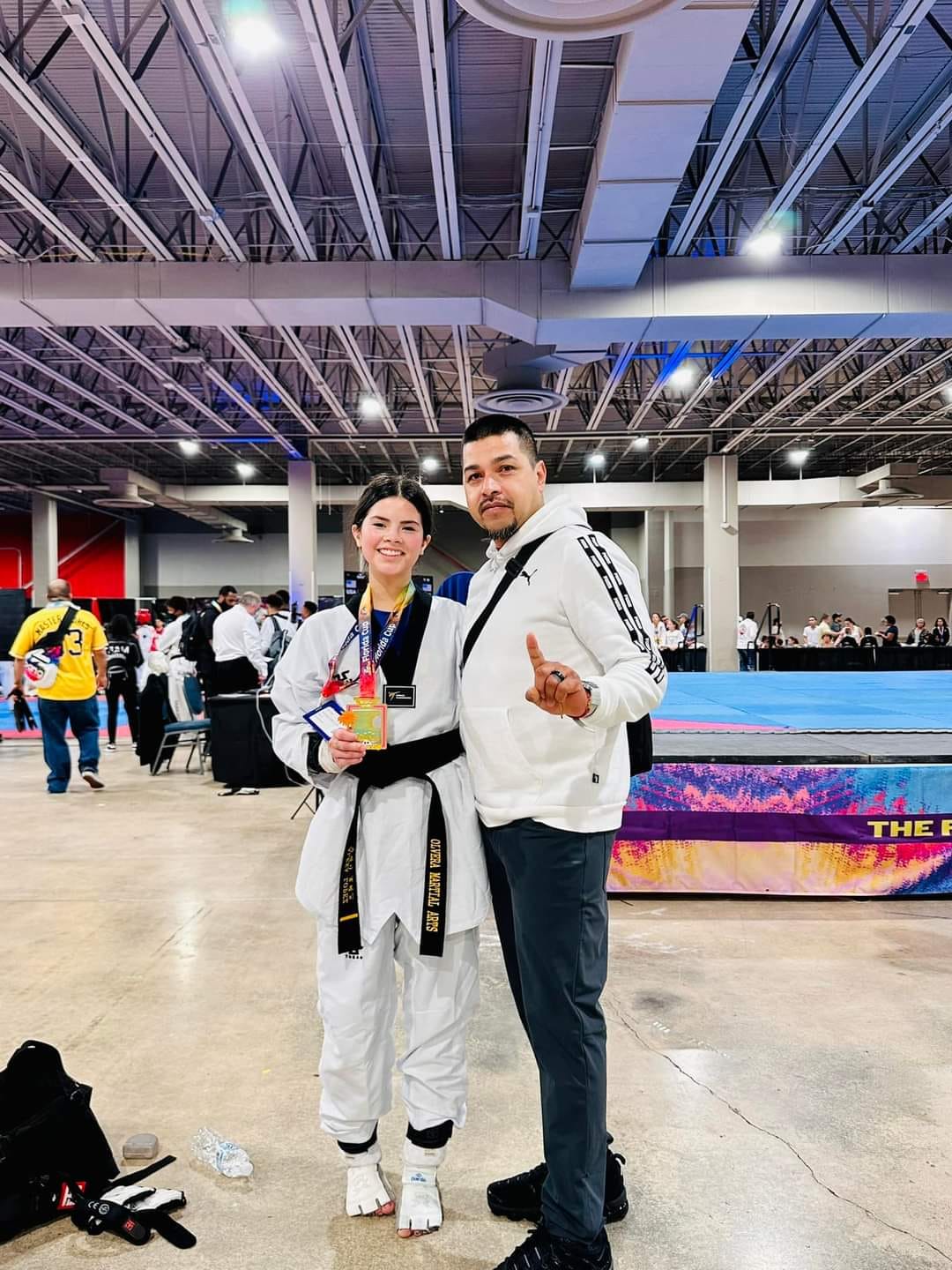 black belt girl with her male instructor