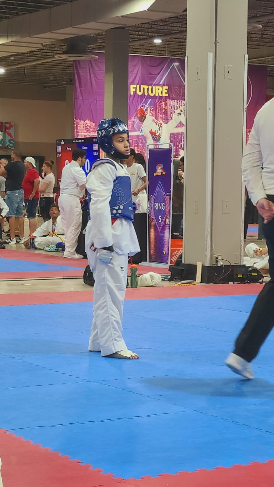 boy competing at a taekwondo tournament